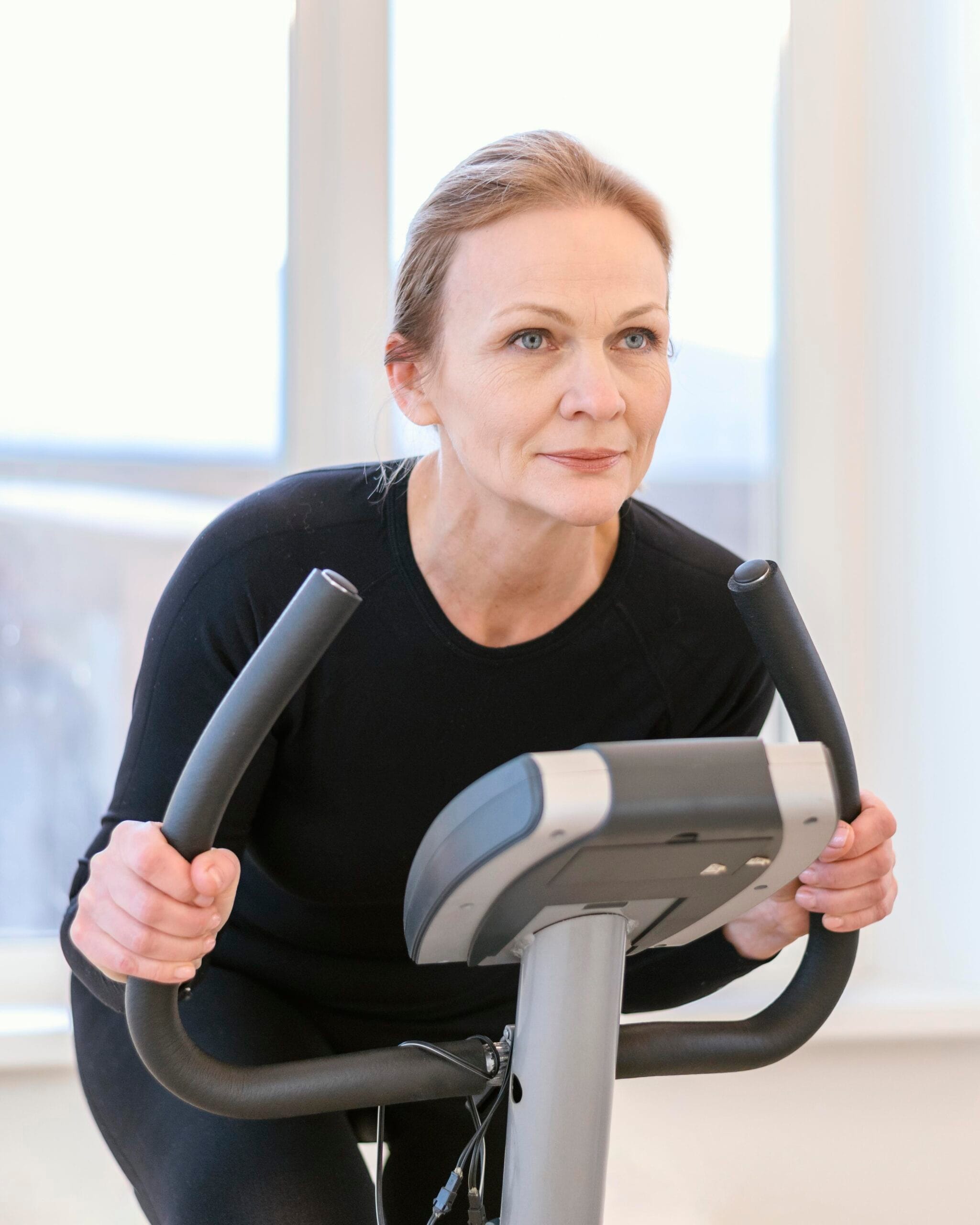 Woman focused on exercise bike workout