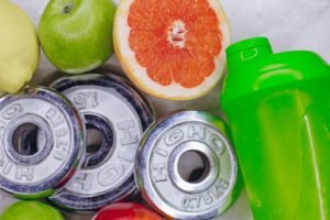 Weights, fruits, and shaker for health and fitness